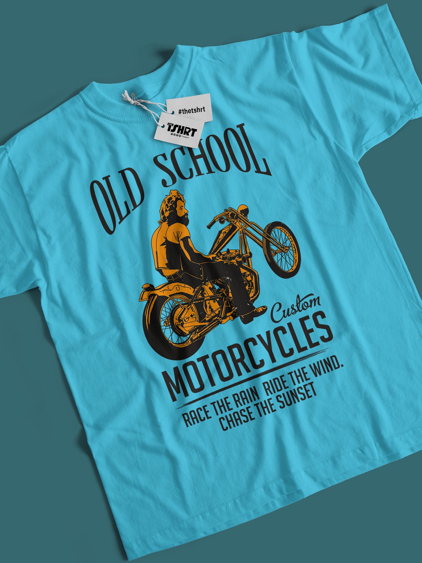 Blue t-shirt with motorcycle graphic and text on a dark teal background
