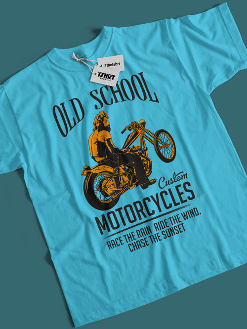 Blue t-shirt with motorcycle graphic and text on a dark teal background