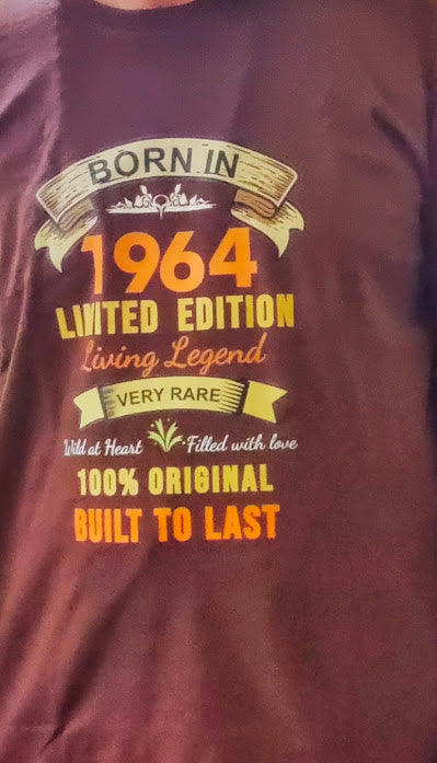 A young rider born in 1964 printed a tshirt saying- Born in 1964 Limited Edition Living Legend, Very rare, 100% original and built to last. on wine color tshirt which is also a maroon mens tshirt from our collection.